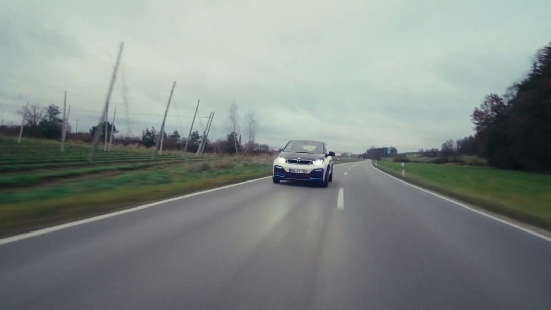 Get Noticed, Continuing the drive, the road, the car, premium production codes. Composition is calm but legible.